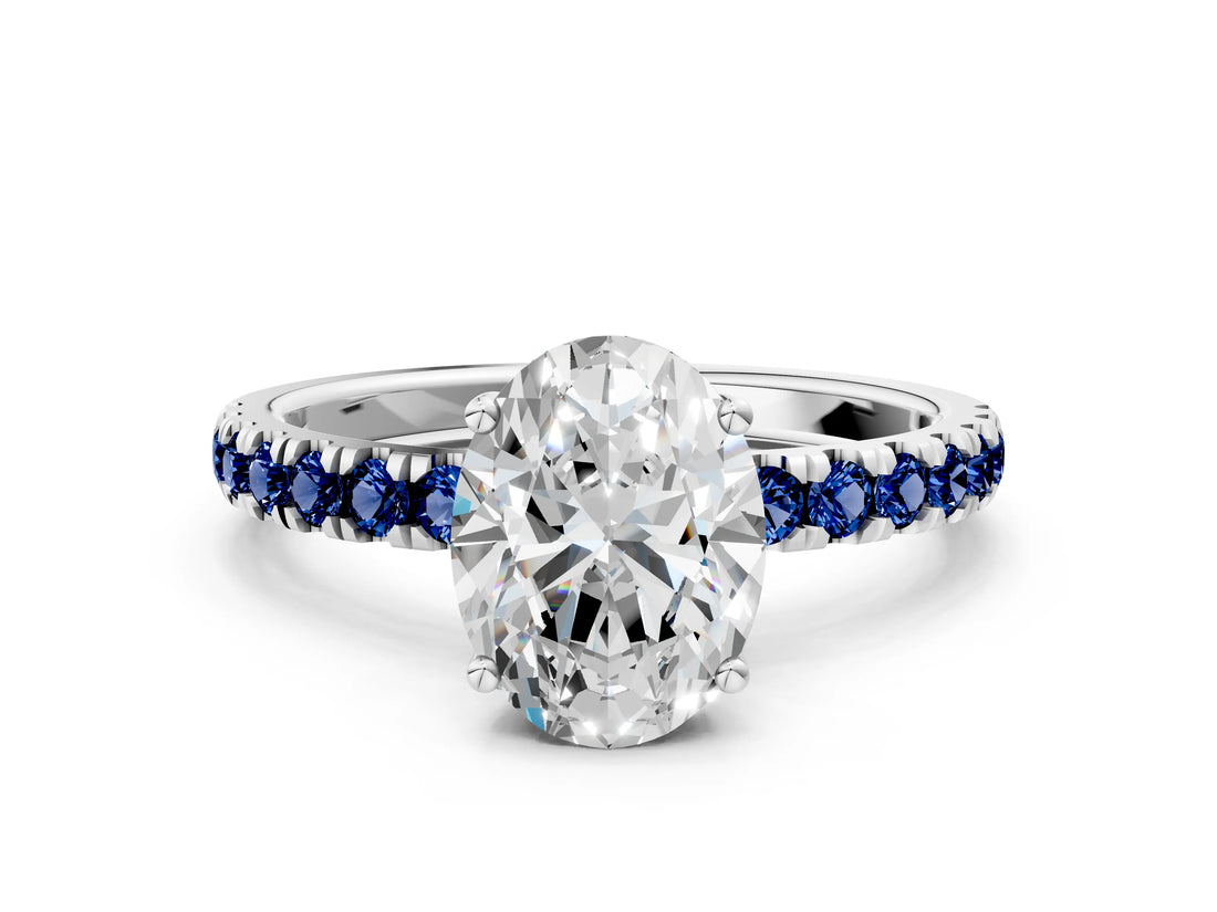 White gold Oval Cut Diamond Pave Band Solitaire Ring with Round with Blue Sapphire side stone and Prong Setting