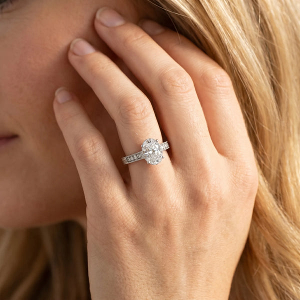 White gold Oval Cut Diamond Ring with Milgrain Pavé Band and Four-Prong Setting