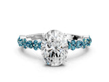 White gold Oval Cut Diamond Side Stone Solitaire Ring with Round with Blue Topaz side stone and Four-Prong Setting