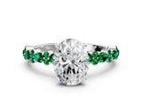 White gold Oval Cut Diamond Side Stone Solitaire Ring with Round with Emerald side stone and Four-Prong Setting