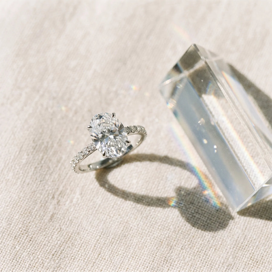 White gold Oval Cut Diamond Solitaire Ring with Micro Pave Band and Four Prong Setting