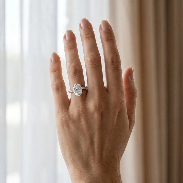 White gold Oval Cut Diamond Solitaire Ring with Pavé Accents and Four-Prong Setting