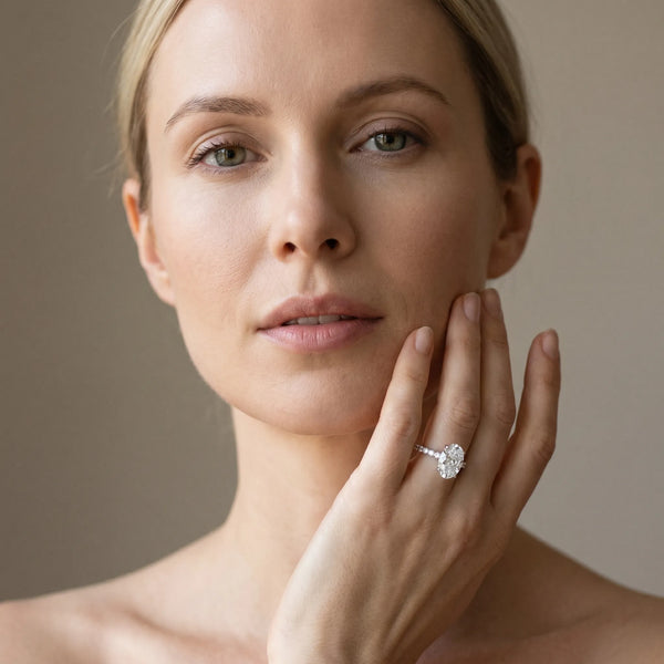 White gold Oval Cut Diamond Solitaire Ring with Pavé Accents and Four-Prong Setting