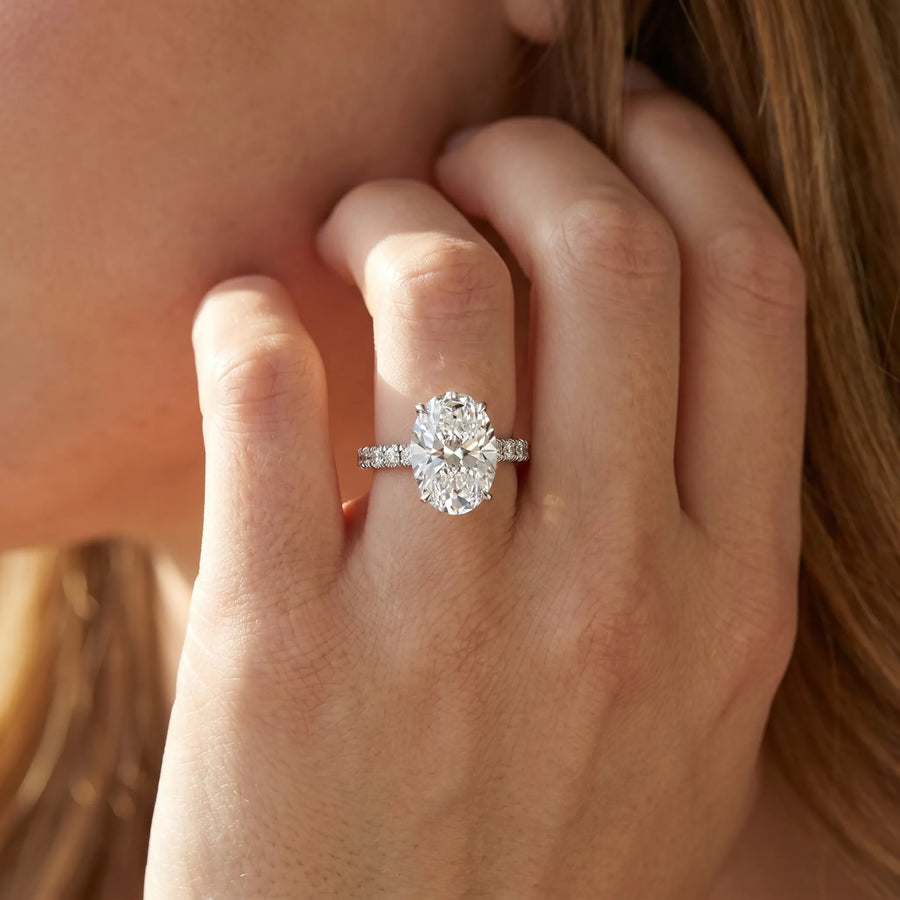 White gold Oval Cut Diamond Solitaire Ring with Pavé Accents and Four-Prong Setting