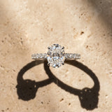 White gold Oval Cut Diamond Solitaire Ring with Pavé Band and Four-Prong Setting_384