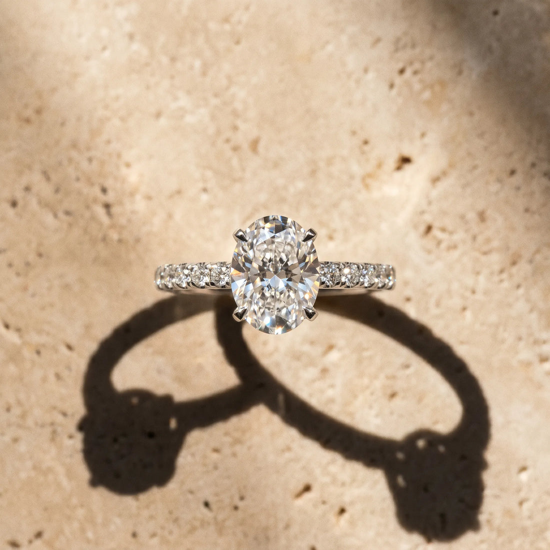 White gold Oval Cut Diamond Solitaire Ring with Pavé Band and Four-Prong Setting_399