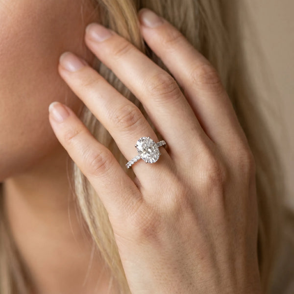White gold Oval Cut Diamond Solitaire Ring with Pavé Band and Hidden Halo