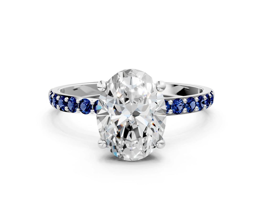 White gold Oval Cut Diamond Solitaire Ring with Round with Blue Sapphire side stone Pavé Band and Prong Setting