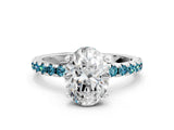 White gold Oval Cut Diamond Solitaire Ring with Round with Blue Topaz side stone Pavé Band and Four-Prong Setting