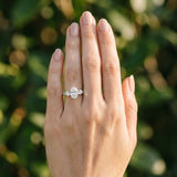 White gold Oval Cut Diamond Three-Stone Ring with Round Side Stones and Pavé Band_123