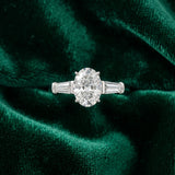 White gold Oval Cut Diamond Three-Stone Ring with Tapered Baguette Side Stones and Prong Setting_30
