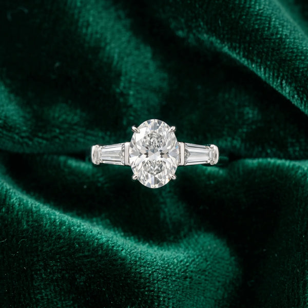 White gold Oval Cut Diamond Three-Stone Ring with Tapered Baguette Side Stones and Prong Setting