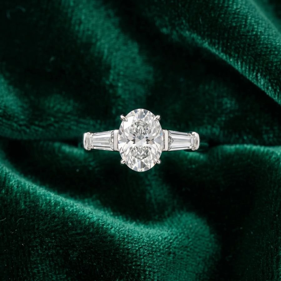 White gold Oval Cut Diamond Three-Stone Ring with Tapered Baguette Side Stones and Prong Setting