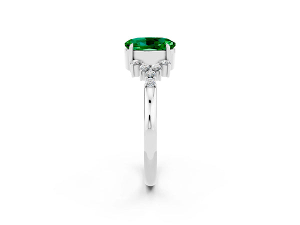 White gold Oval Cut Emerald Ring with Side Stones and Four-Prong Setting