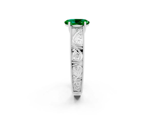 Silver Oval Cut Emerald Solitaire Ring with Engraved Band and Four-Prong Setting