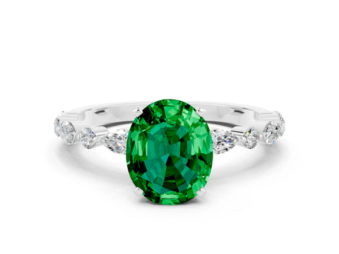 White gold Oval Cut Emerald Solitaire with Side Stones on a Pavé Band and Four-Prong Setting