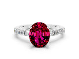 White gold Oval Cut Garnet Solitaire with Side Baguettes and Channel Set Band
