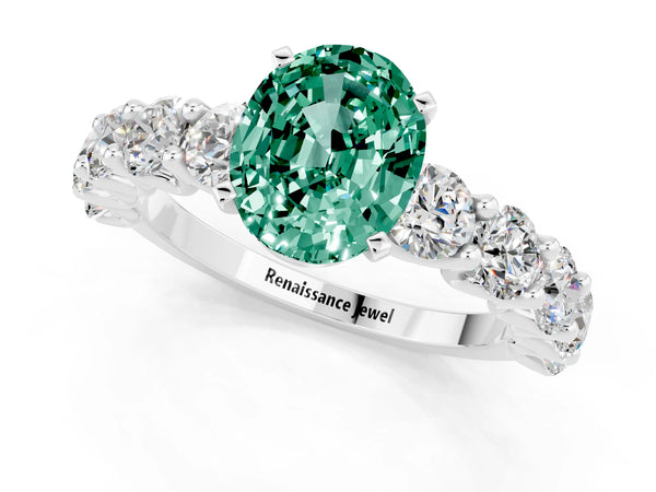 Platinum Oval Cut Green Sapphire Prong Setting with Side Stones on a Pave Band