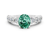 White gold Oval Cut Green Sapphire Prong Setting with Side Stones on a Pave Band