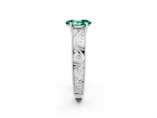 Platinum Oval Cut Green Sapphire Solitaire Ring with Engraved Band and Four-Prong Setting
