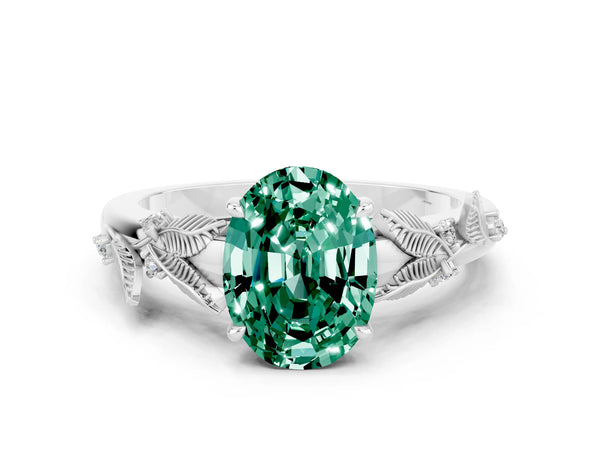 Platinum Oval Cut Green Sapphire Solitaire Ring with Leaf Motif Band and Four-Prong Setting