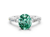 White gold Oval Cut Green Sapphire Solitaire with Side Baguettes and Channel Set Band