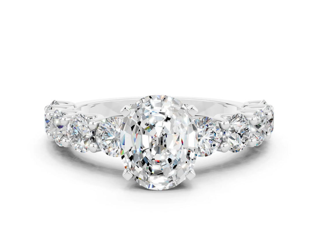 White gold Oval Cut Moissanite Prong Setting with Side Stones on a Pave Band