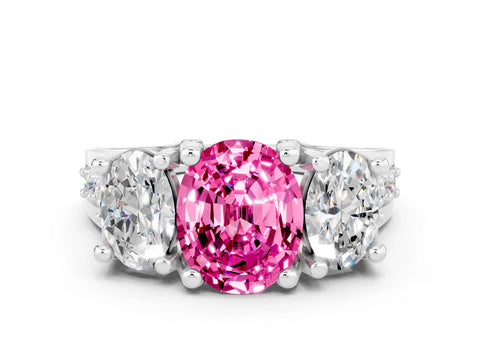 White gold Oval Cut Pink Sapphire Three-Stone Ring with Channel Set Band and Four-Prong Setting