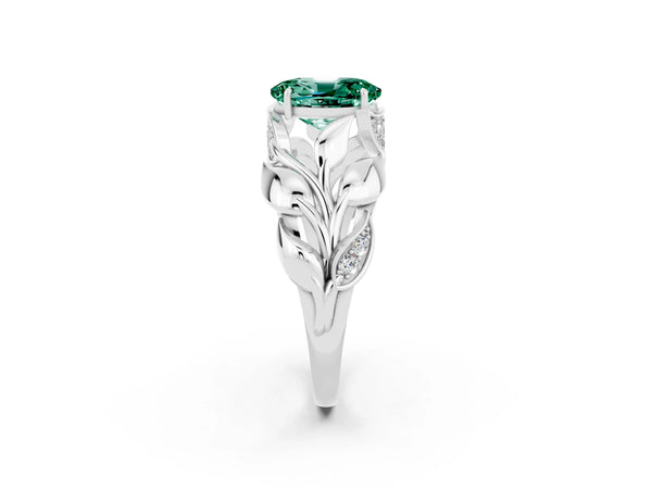 Platinum Oval Cut Green Sapphire Leaf-Inspired Engagement Ring with Round Accents and Prong Setting