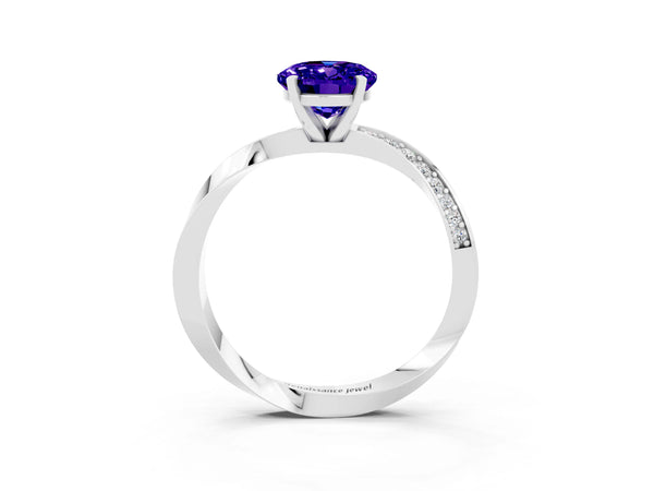 Silver Oval Cut Tanzanite Engagement Ring with Side Stone Accents and Four-Prong Setting