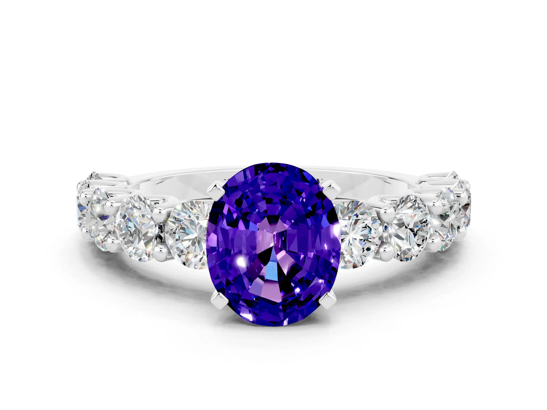 White gold Oval Cut Tanzanite Prong Setting with Side Stones on a Pave Band