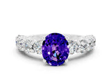 White gold Oval Cut Tanzanite Prong Setting with Side Stones on a Pave Band