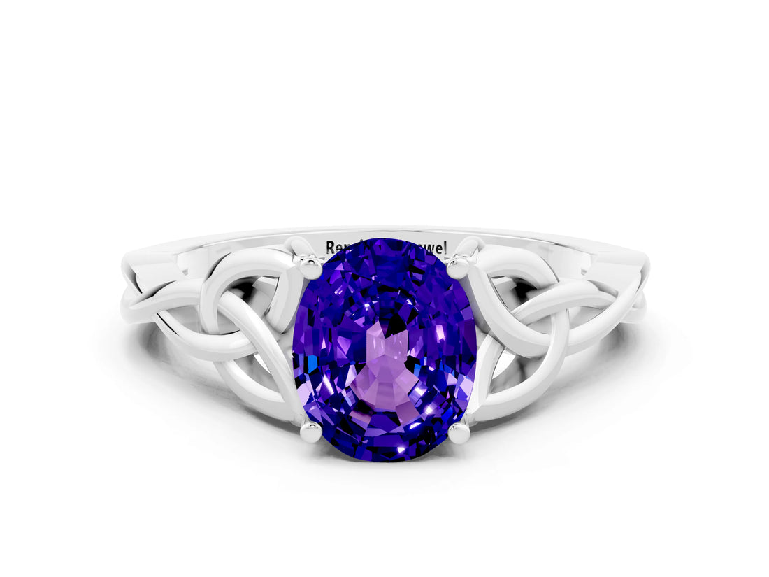 White gold Oval Cut Tanzanite Solitaire Engagement Ring with Celtic Knot Band and Four-Prong Setting