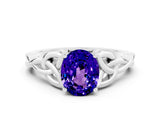 White gold Oval Cut Tanzanite Solitaire Engagement Ring with Celtic Knot Band and Four-Prong Setting