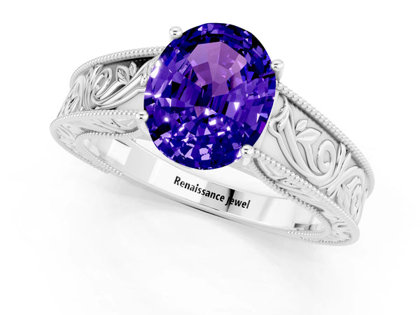 White gold Oval Cut Tanzanite Solitaire Ring with Engraved Band and Four-Prong Setting