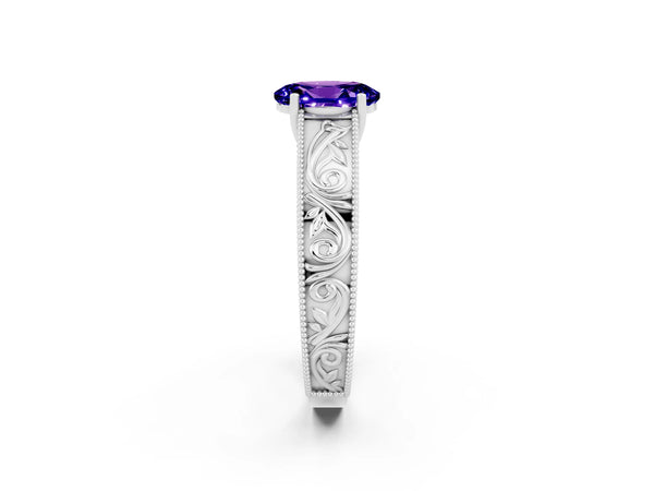 White gold Oval Cut Tanzanite Solitaire Ring with Engraved Band and Four-Prong Setting