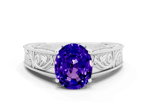 White gold Oval Cut Tanzanite Solitaire Ring with Engraved Band and Four-Prong Setting