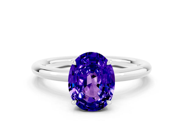 Platinum Oval Cut Tanzanite Solitaire Ring with Thin Band and Four-Prong Setting