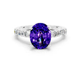 White gold Oval Cut Tanzanite Solitaire with Side Baguettes and Channel Set Band