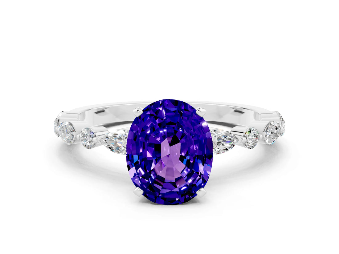 White gold Oval Cut Tanzanite Solitaire with Side Stones on a Pavé Band and Four-Prong Setting