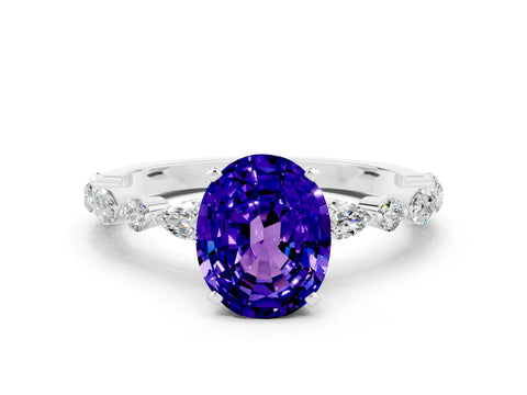 White gold Oval Cut Tanzanite Solitaire with Side Stones on a Pavé Band and Four-Prong Setting