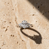 White gold Oval Cut Three-Stone Diamond Ring with Pear Side Stones on a Classic Solitaire Band with Prong Setting_25
