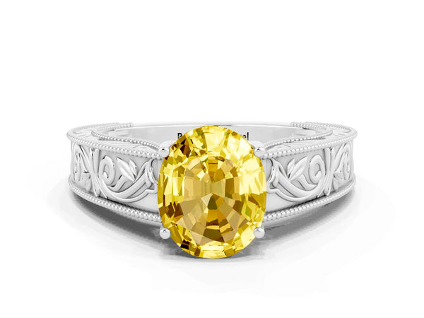 White gold Oval Cut Yellow Sapphire Solitaire Ring with Engraved Band and Four-Prong Setting
