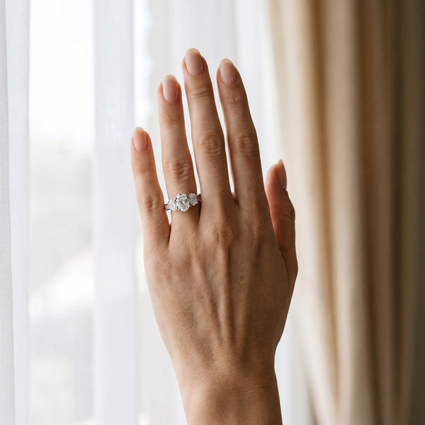 Platinum 4.01 Carat F VVS2 Oval Diamond Three-Stone Ring with Prong Setting and Textured Band