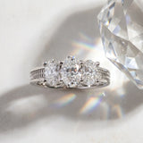 Platinum 4.01 Carat F VVS2 Oval Diamond Three-Stone Ring with Prong Setting and Textured Band