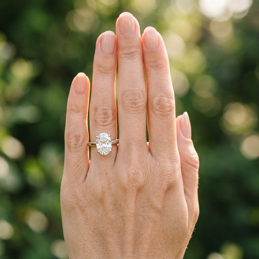 White gold Oval Solitaire Diamond Engagement Ring with Four-Prong Setting on a Classic Band