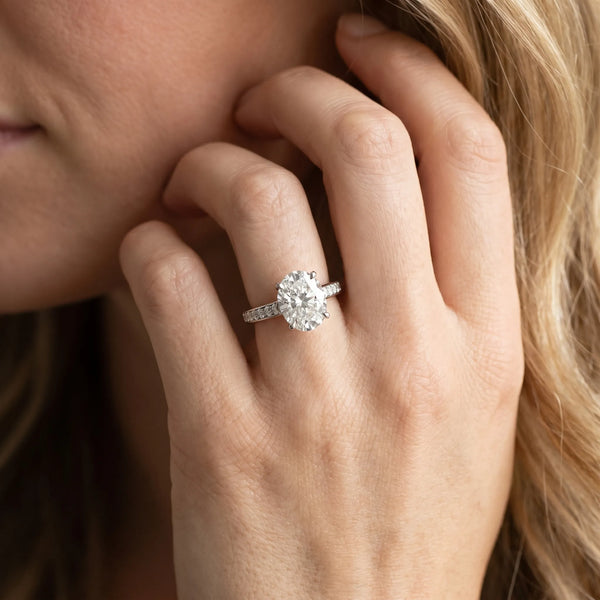 White gold Oval Solitaire Prong Set Diamond Engagement Ring with Pave Band