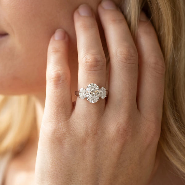 White gold Oval Three-Stone Diamond Ring with Prong Setting on a Classic Band