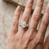 White gold Pear Brilliant Solitaire with Side Stones on a Pave Band and Four-Prong Setting_14