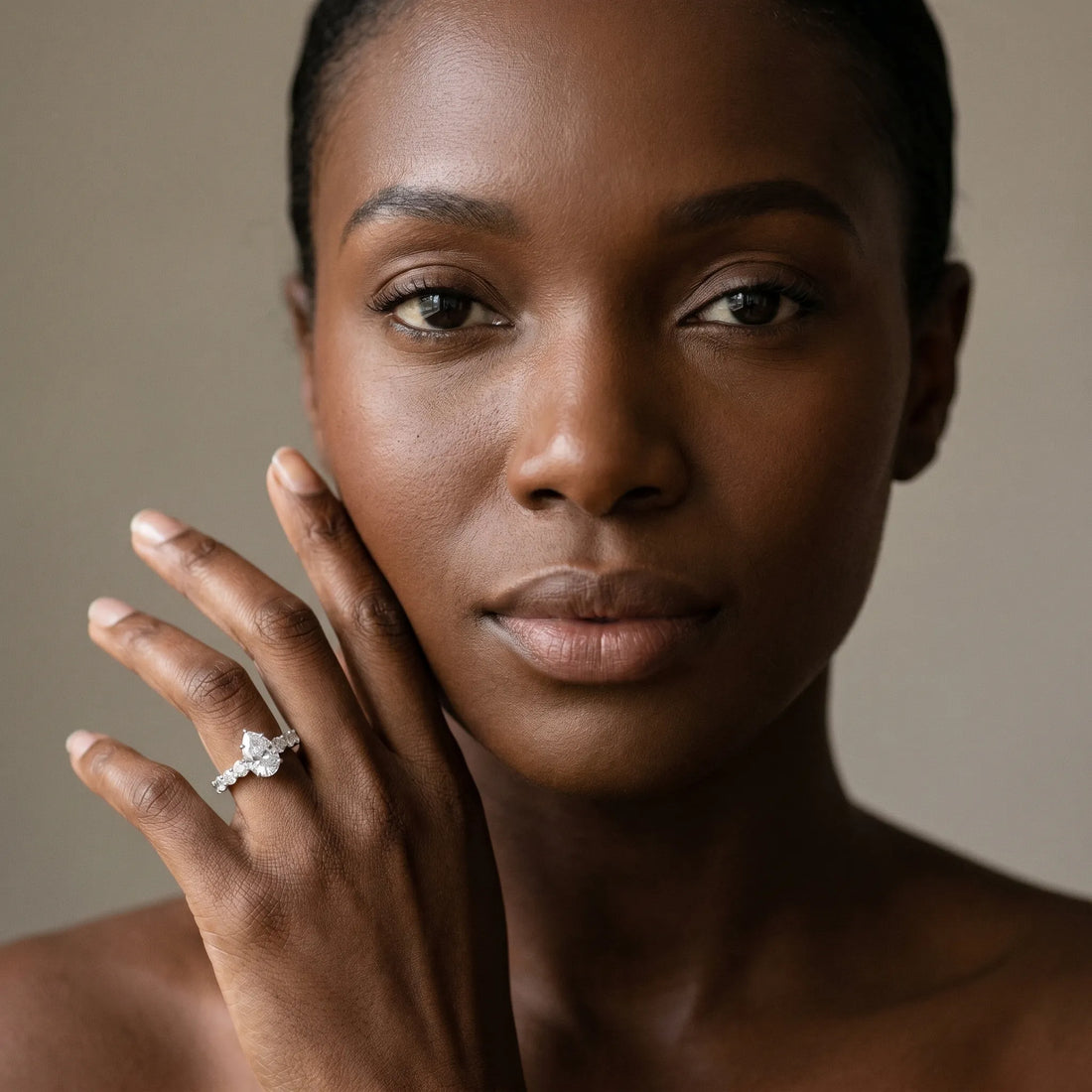 White gold Pear Brilliant Solitaire with Side Stones on a Pave Band and Four-Prong Setting_15